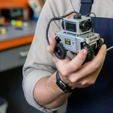 A small camera rover held in two hands